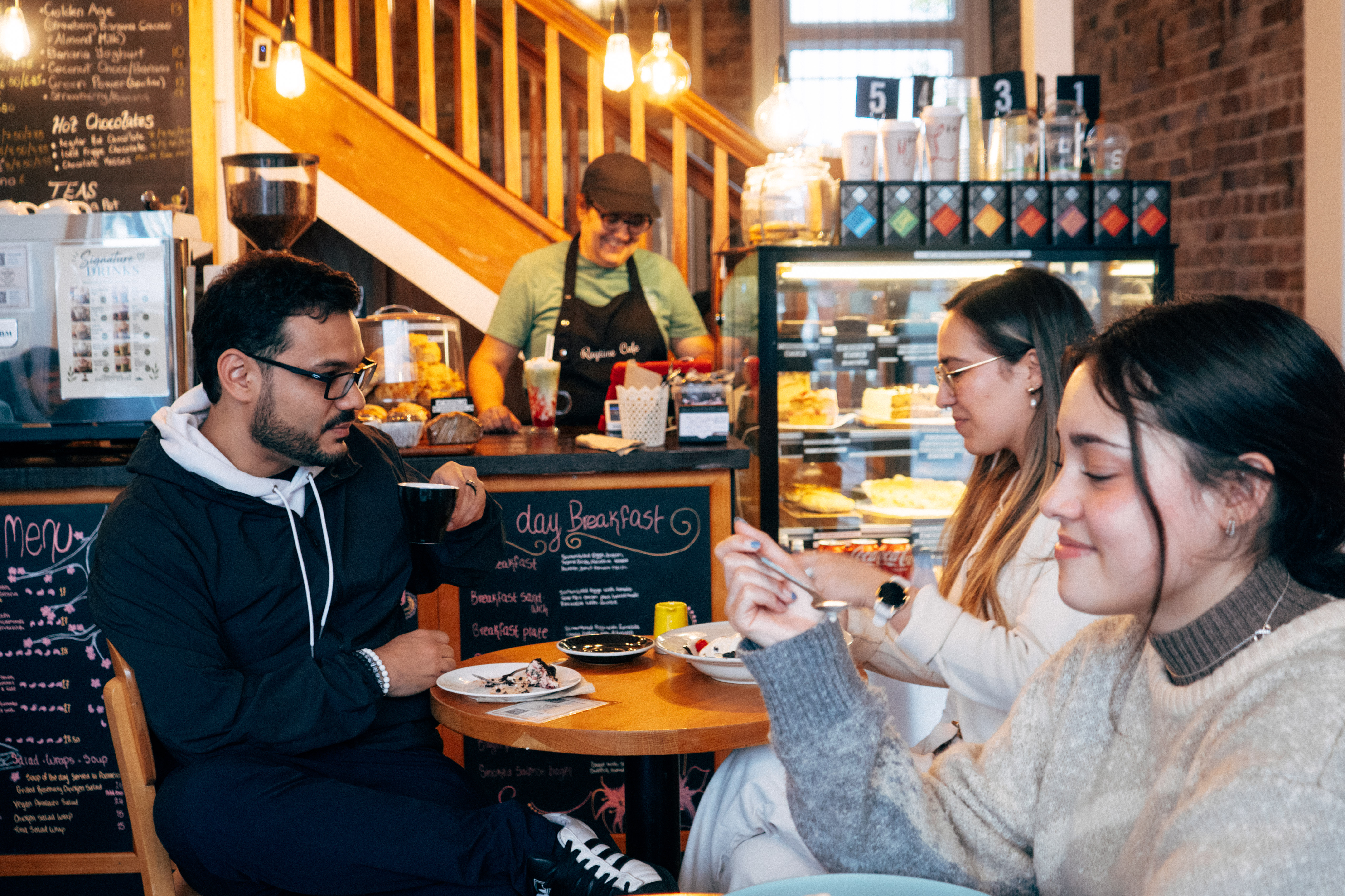 Friends enjoying coffee together inside Ragtime Café